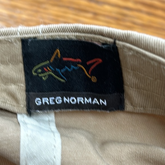 Greg Norman brand tan cap.  Velcro to adjust size in back.  Good condition. OS - Picture 6 of 8